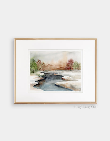 Gold framed mock up of icy stream divides watercolor landscape into two snowy fields