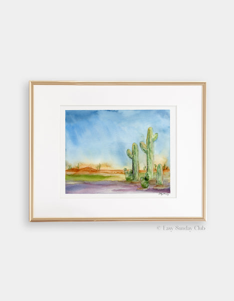 gold-framed mock up cactus watercolor in a desert landscape, desert themed art print with bright and saturated colors