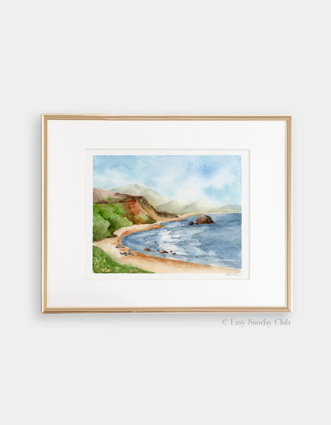 Gold framed mock up of blue ocean cove surrounded by green hills and three seals on the beach watercolor landscape