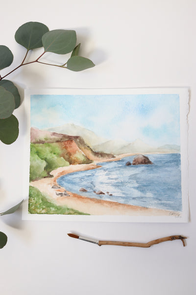 blue ocean cove surrounded by green hills and three seals on the beach watercolor landscape flat lay
