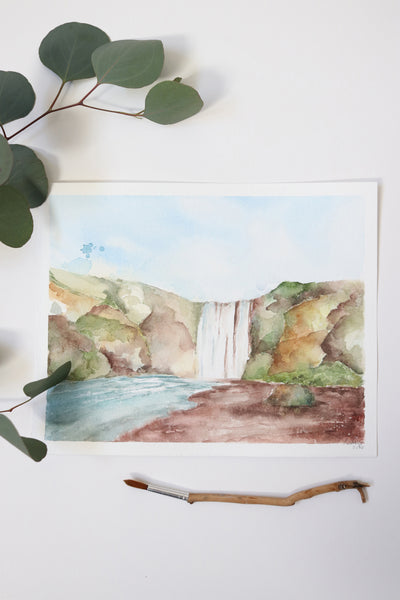 giant waterfall in center of rocky green landscape watercolor flay lay
