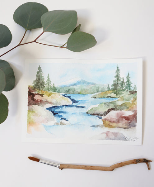 rocky stream rolls down from a mountain tucked away in a forest watercolor landscape flat lay