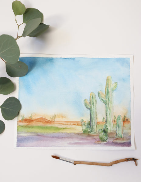 flat lay image of cactus watercolor in a desert landscape, desert themed art print with bright and saturated colors