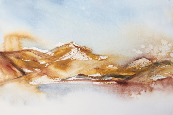 Rich earth-tone washes of color reveal a desert hill watercolor landscape close up