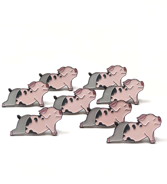 an army of yoga pig enamel pins